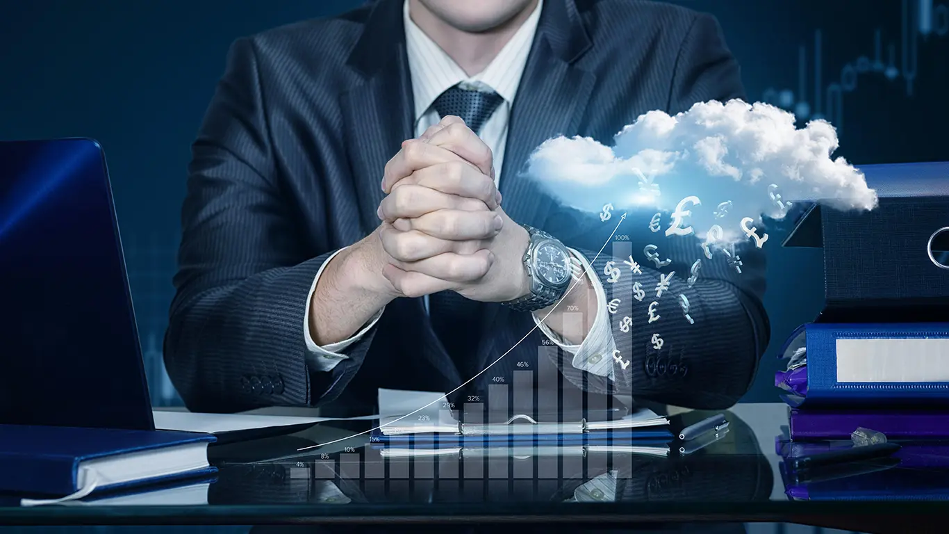 Man sites on desk with cloud image