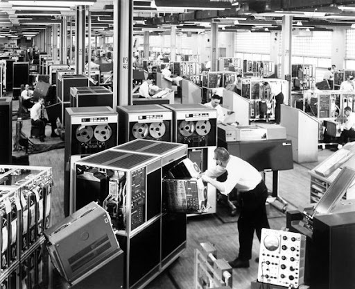 Person working at a large, early computer way before cloud computing.
